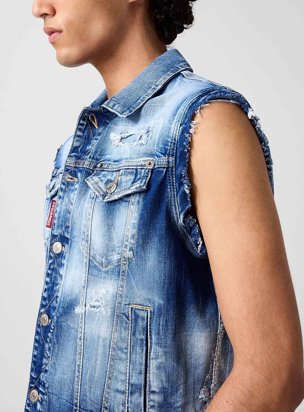 Distressed sleeveless denim jacket