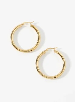 Large golden tubular hoops
