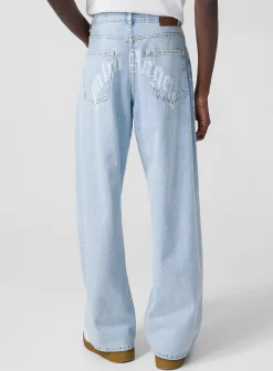 Light blue wide-leg jeans with curved logo