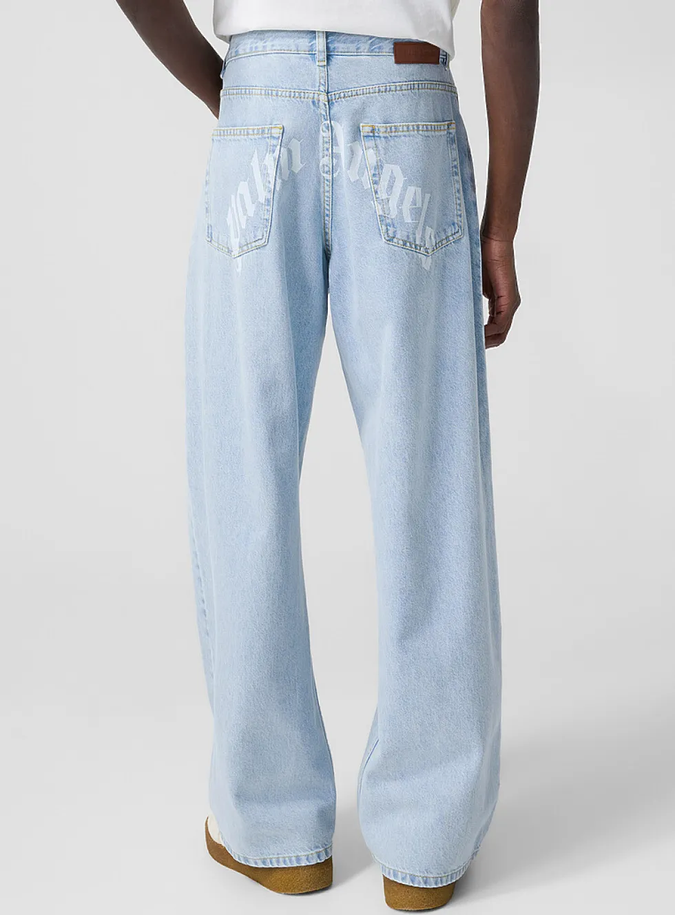 Light blue wide-leg jeans with curved logo