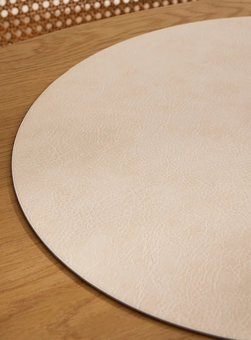 Round faux-leather placemat