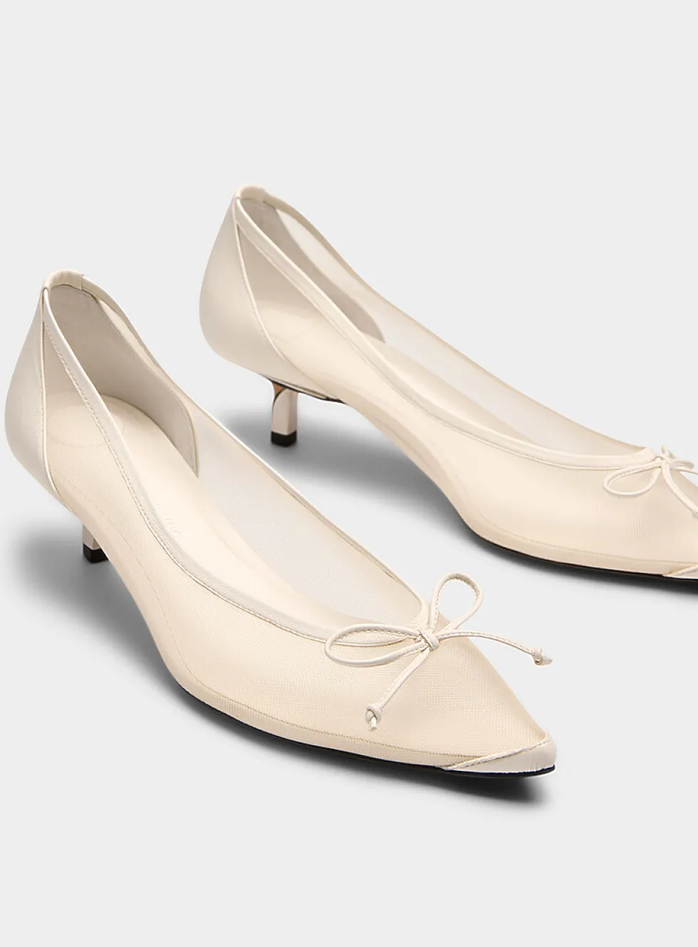 Tourni twisted heel sheer pumps